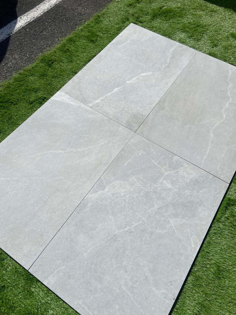 Bodo White porcelain paving slabs laid on an outdoor garden terrace in the UK
