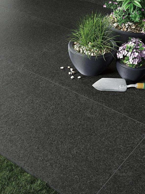 Black basalt porcelain paving slabs laid on an outdoor patio terrace