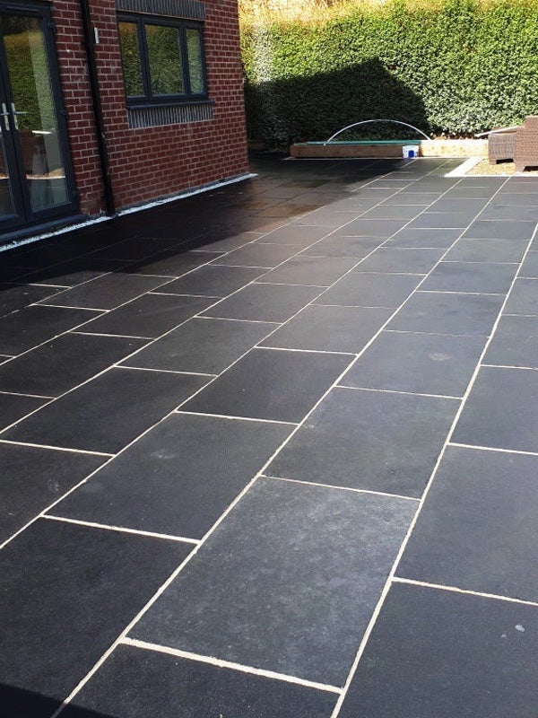 Natural black limestone slabs, textured stone for gardens, paths, and landscaping.