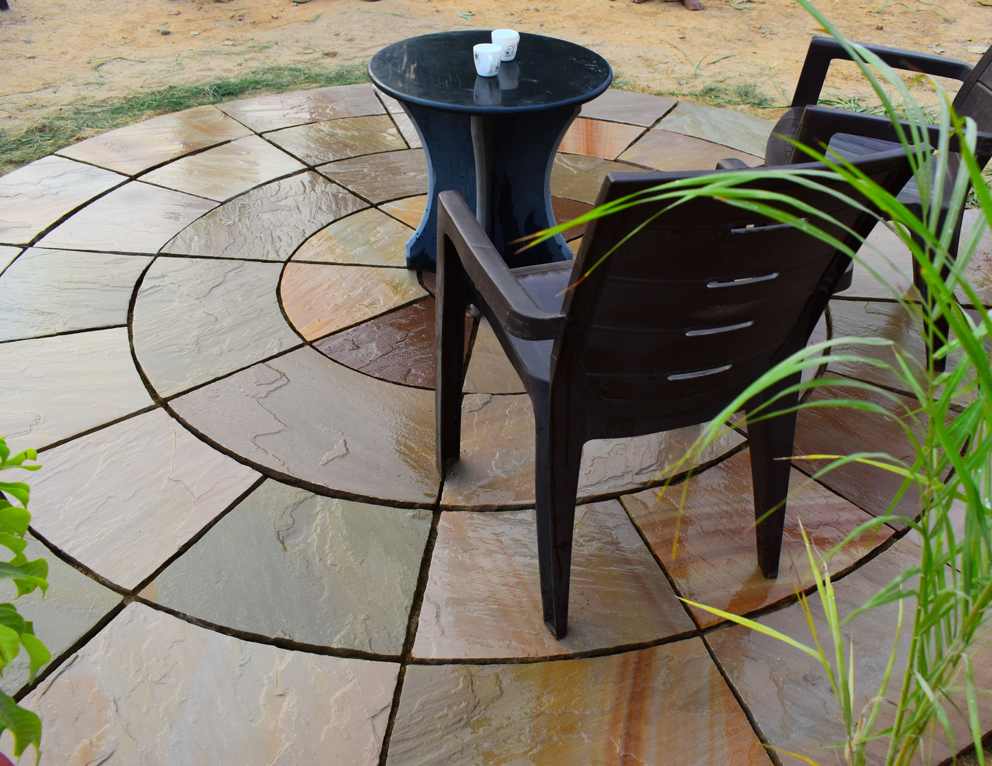 Buff-colored circular flagstone, decorative patio paving.