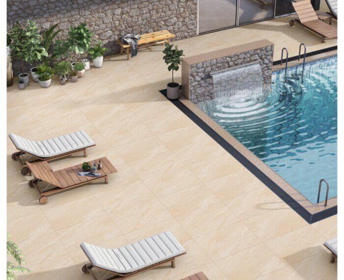 Outdoor pool seating area with Canterbury Beige porcelain paving