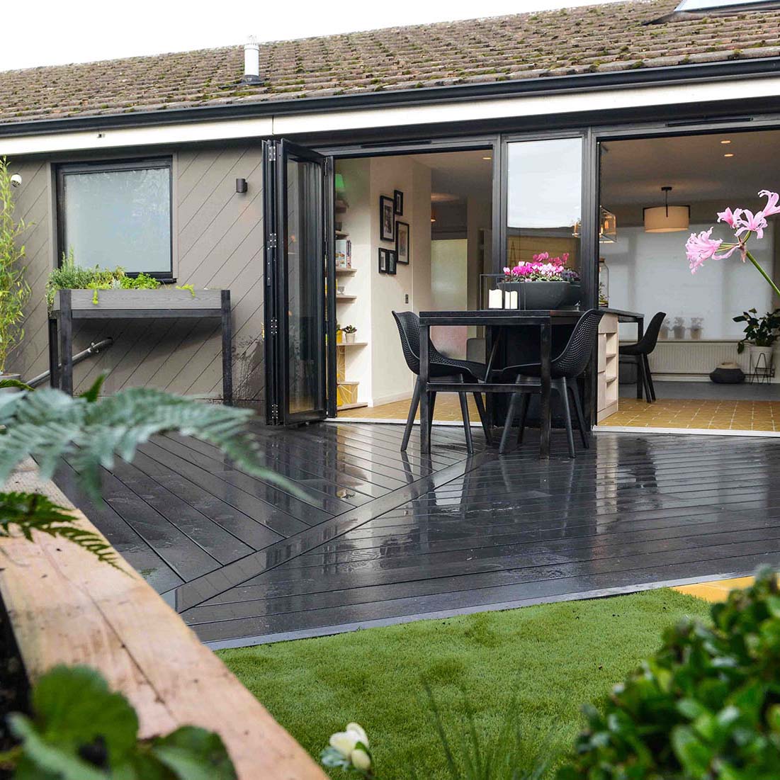 Close-up of black decking composite with realistic timber texture and grooved edges