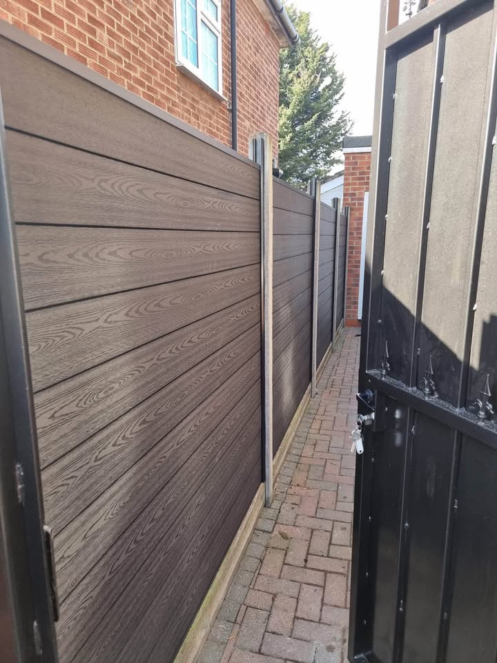 Oak composite fencing panel set fitted along a residential garden boundary