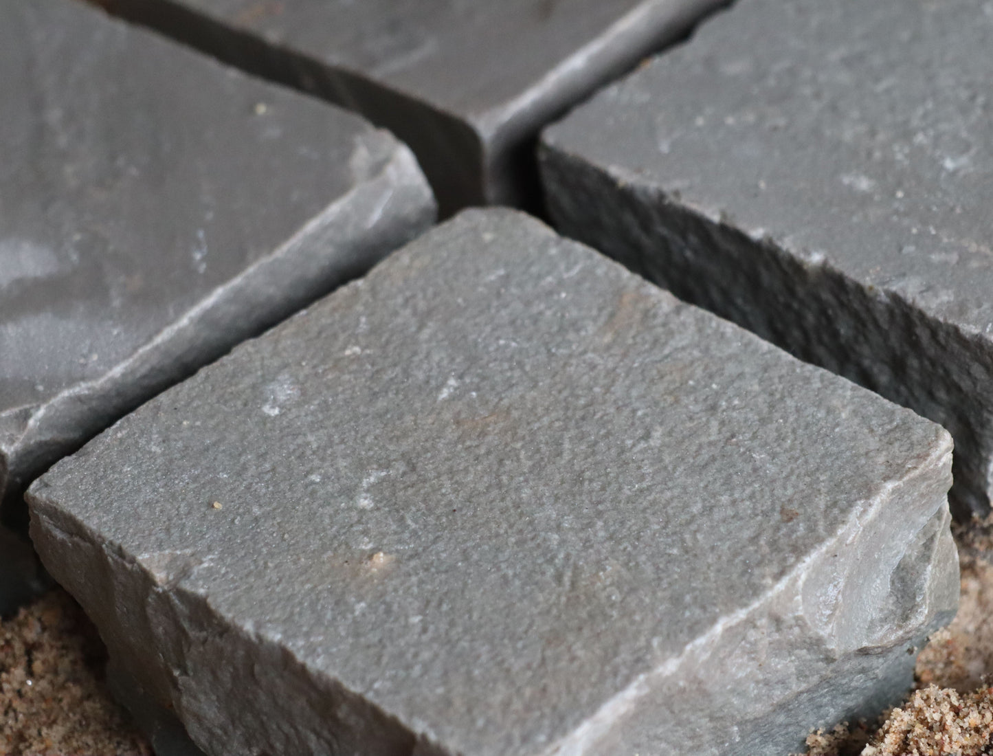 Natural Kandla Grey cobblestones, textured finish, ideal for edging and patios.
