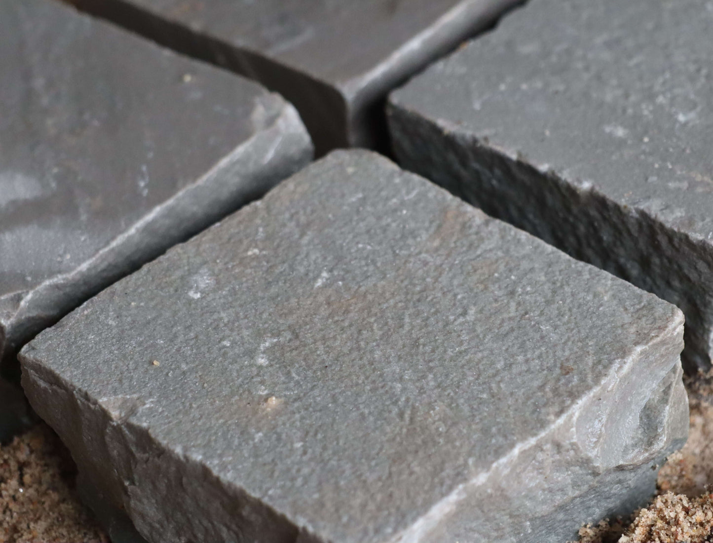 Natural Kandla Grey cobblestones, textured finish, ideal for edging and patios.