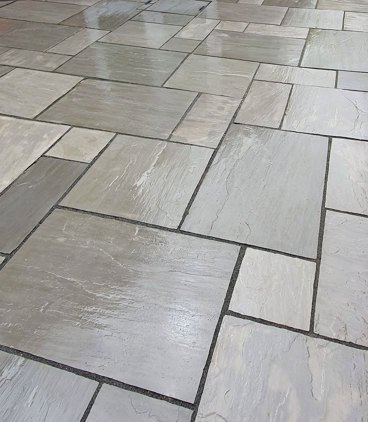 Kandla Grey paving slabs, durable Indian sandstone with a textured surface for garden and driveway use.