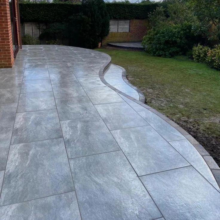Porcelain patio slabs in London Grey, smooth finish for contemporary outdoor spaces.
