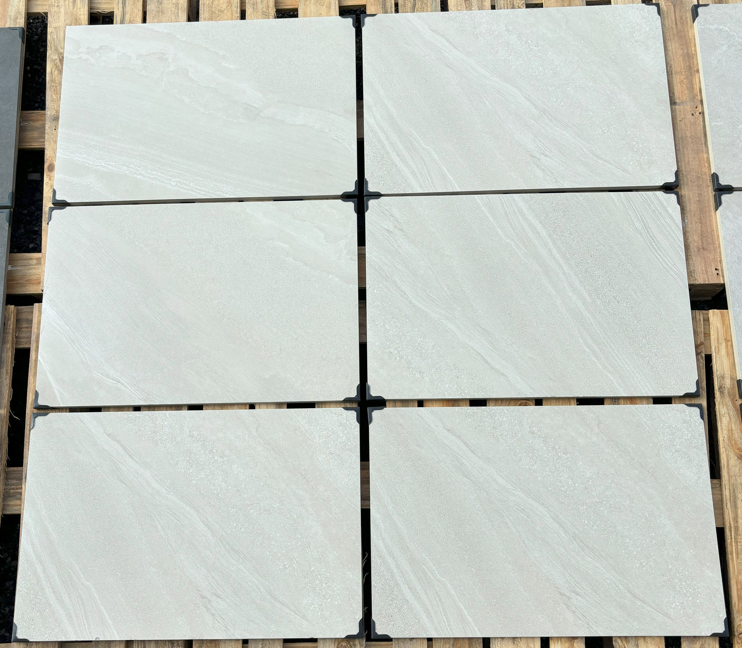 Porcelain patio slabs in Norfolk White, sleek white tiles for contemporary outdoor spaces.