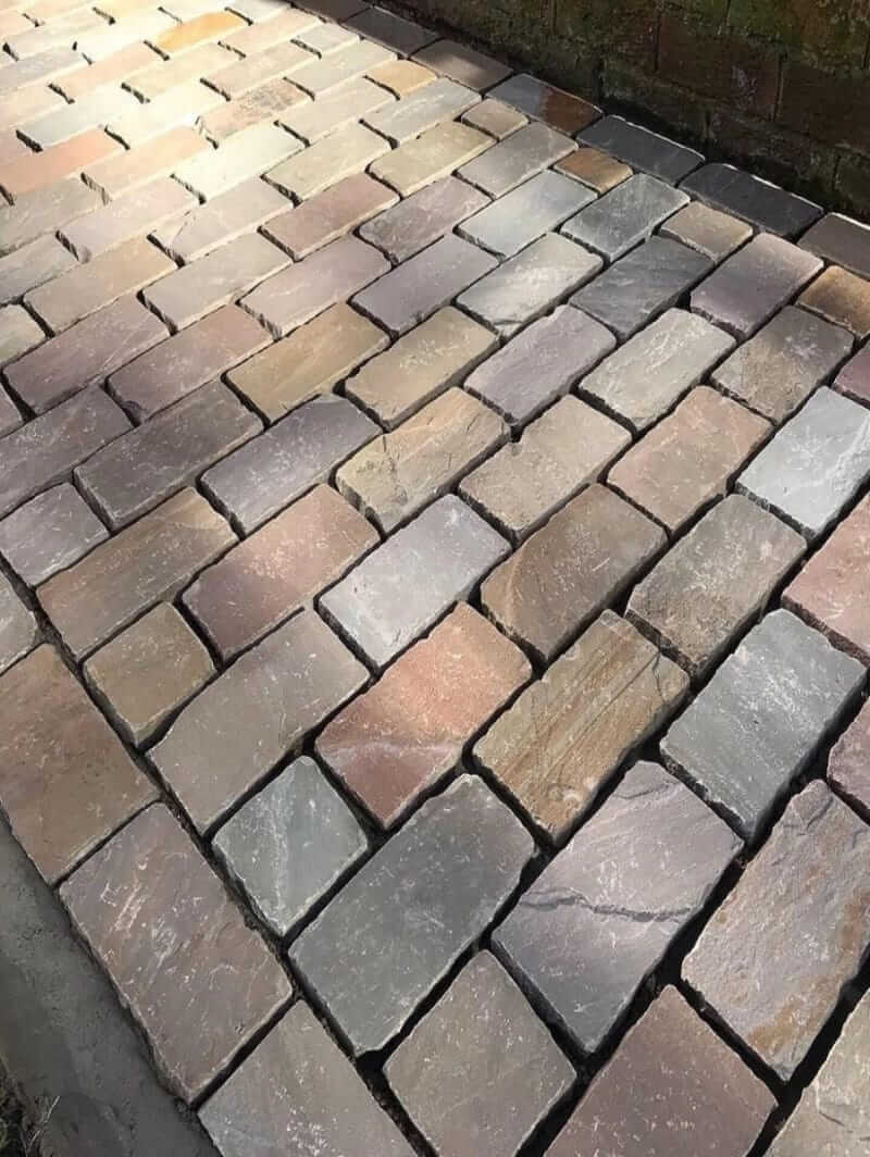 raj green cobblestones natural split surface laying image in the uk garden