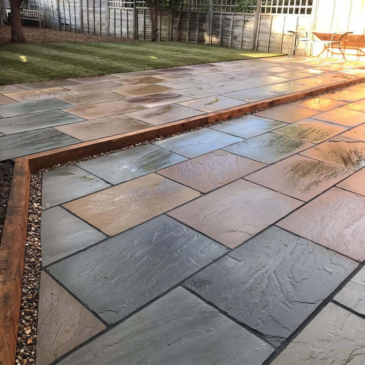 Raj Green Indian sandstone paving slabs, natural mix of green and brown tones.