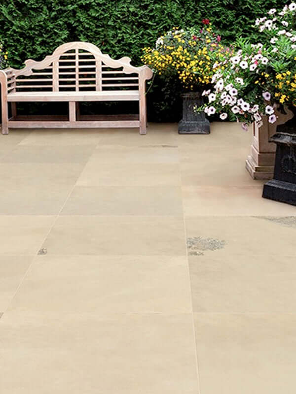 Combining irregular flagstones with climbing plants for a cottage garden patio