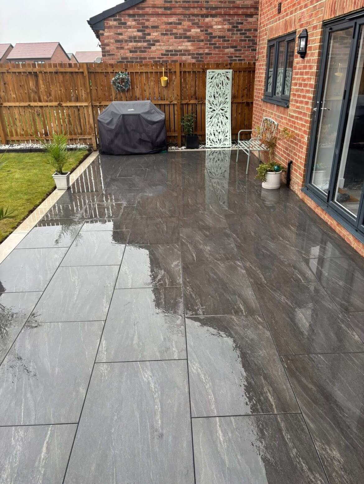Anthracite Dark Porcelain paving Slabs installed in the outdoor garden in a house in the UK