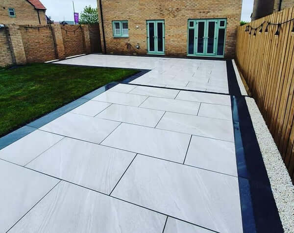 Residential driveway paved with Crossover White paving slabs