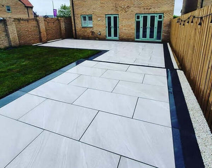 Residential driveway paved with Crossover White paving slabs
