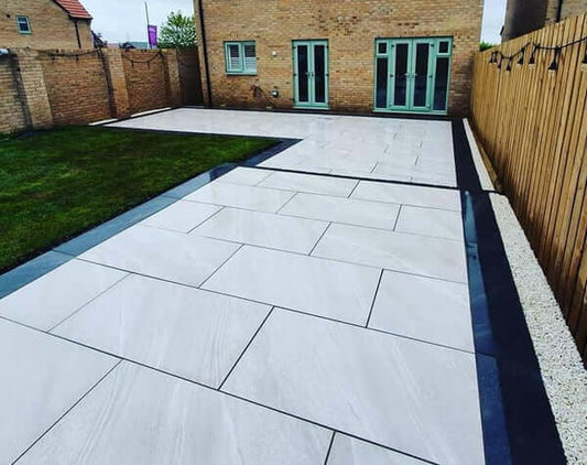 Residential driveway paved with Crossover White paving slabs