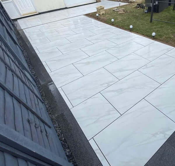 UK residential property with Stutuario Marble porcelain patio paving