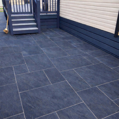 Anthracite dark porcelain patio pack slabs installed in a modern garden