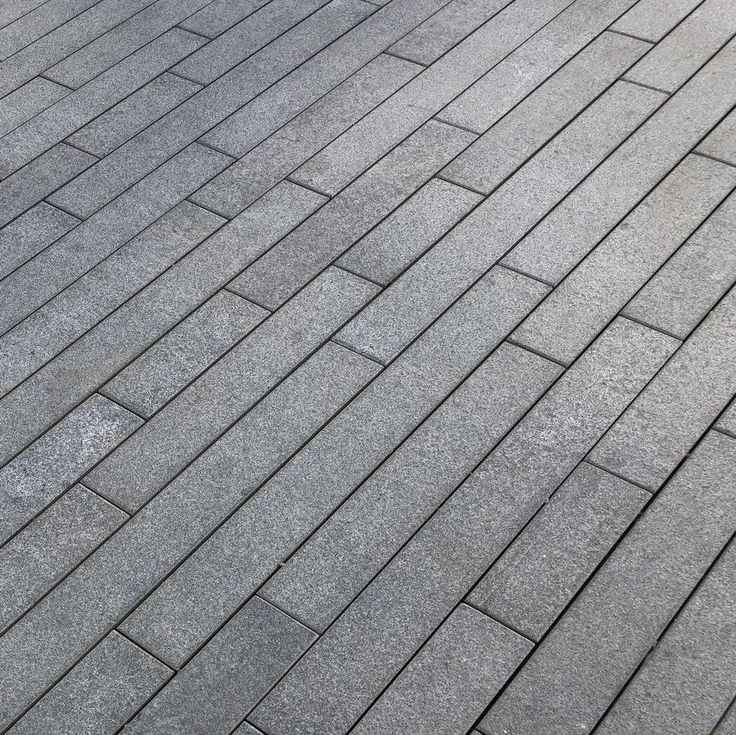 Black granite paving planks, sleek linear natural stone tiles for modern outdoor spaces.