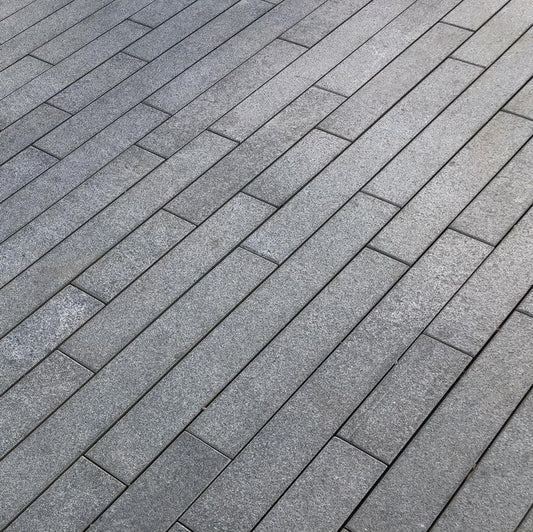 Black granite paving planks, sleek linear natural stone tiles for modern outdoor spaces.