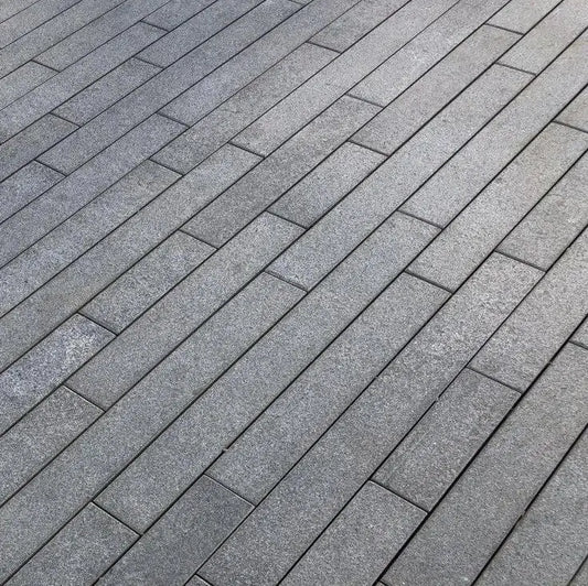 Black granite paving planks, sleek linear natural stone tiles for modern outdoor spaces.