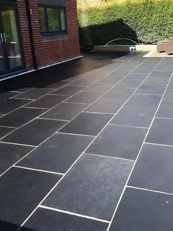 Natural black limestone slabs, textured stone for gardens, paths, and landscaping.