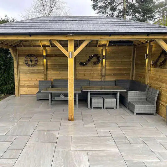 Garden dining area patio finished with Kandla Grey porcelain patio slabs