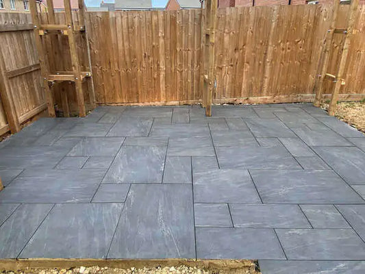 Manchester Midnight dark porcelain patio paving slabs installed in an outdoor garden in the UK
