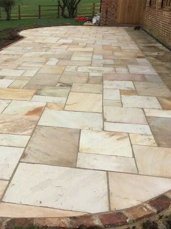 mint fossil patio pack indian sandstone laying in the garden in the uk