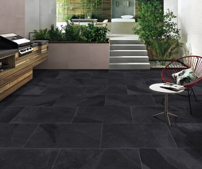 Newcastle Black porcelain paving slabs, deep black finish for sleek modern patios.