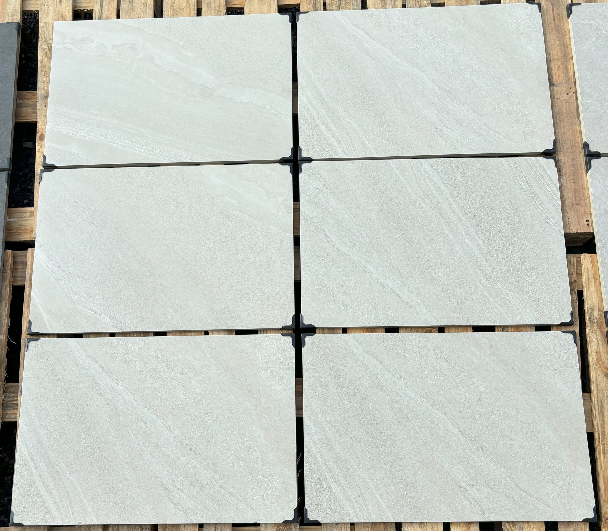 Porcelain patio slabs in Norfolk White, sleek white tiles for contemporary outdoor spaces.
