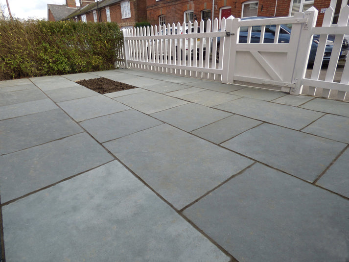 Tandur Grey Limestone paving slabs, natural riven finish, ideal for patios.