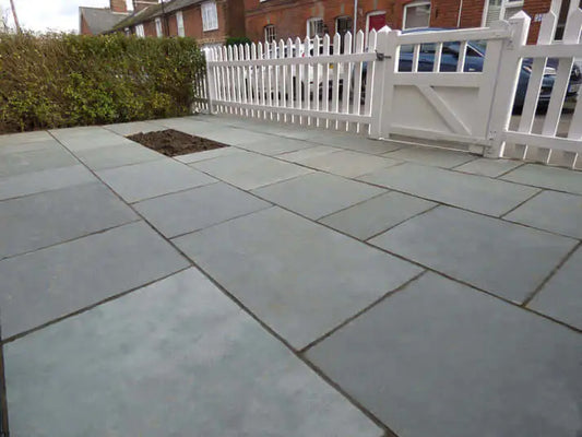 Tandur Grey limestone paving slabs laid in a landscaped UK garden